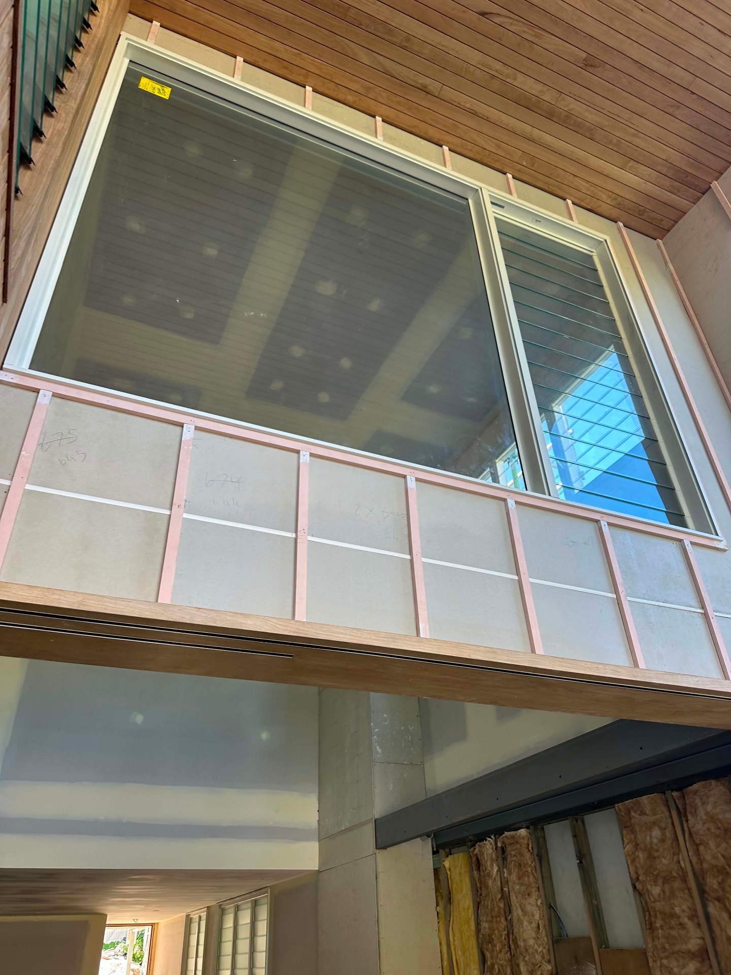 Timber-lined ceiling above a kitchen mid-finish
